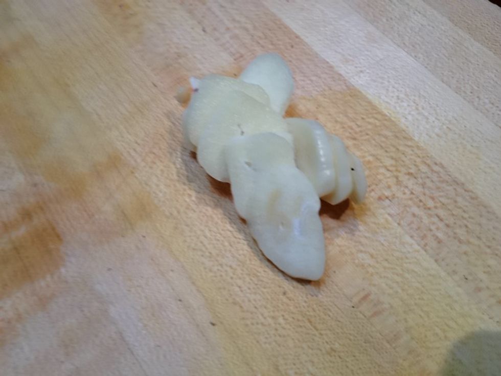 Thinly slice two garlic cloves.