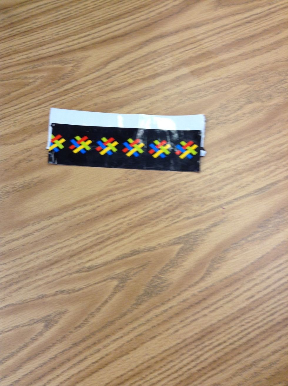 Third, cut out another piece the same size and put the sticky part down on half of the other piece.