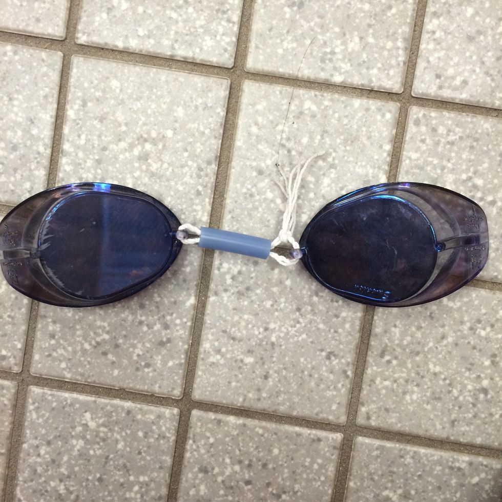 Third, push one end of the string through the other goggle and tie a knot with the two ends. Make sure the string is the right length to fit your nose. This is the most difficult part.