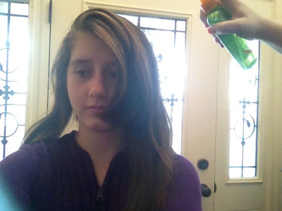 Third Section: Release the hair in the bun and part the last section of hair however you'd like. Then spray it with heat protectant.