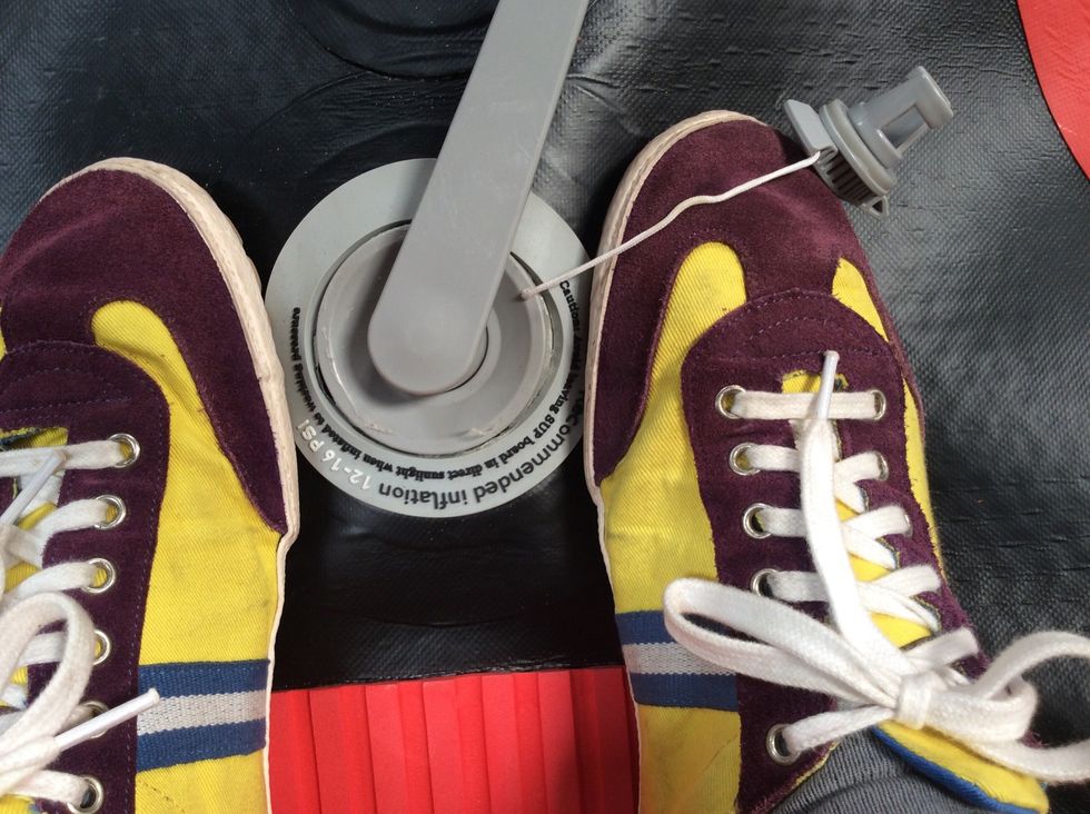 Third, stand on either side of the valve. This prevents the female part of the valve from spinning inside your board.  You are simply applying downward pressure.