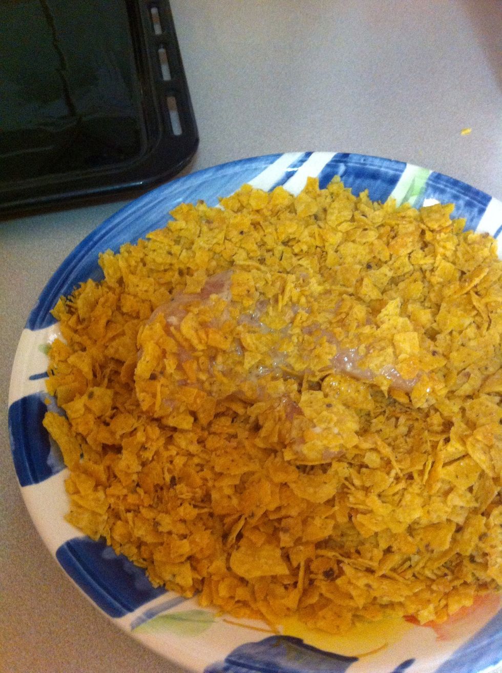 Third step: Coat the chicken with the dorito crumbs. Repeat this process with the rest of the chicken.