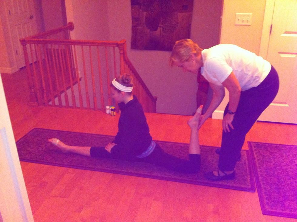 Third stretch (Part 1 or 2): On a carpet or mat, get into your splits. Have your partner lift up your back leg slowly and use one hand to grab ahold of it...