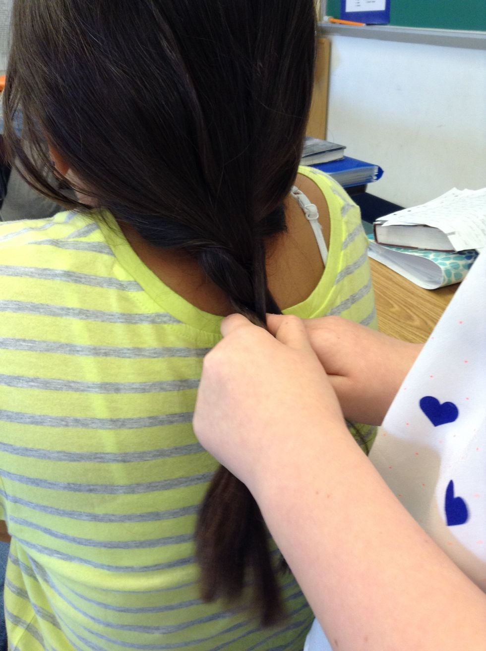 Third, take the left section of hair and switch it with the middle section.