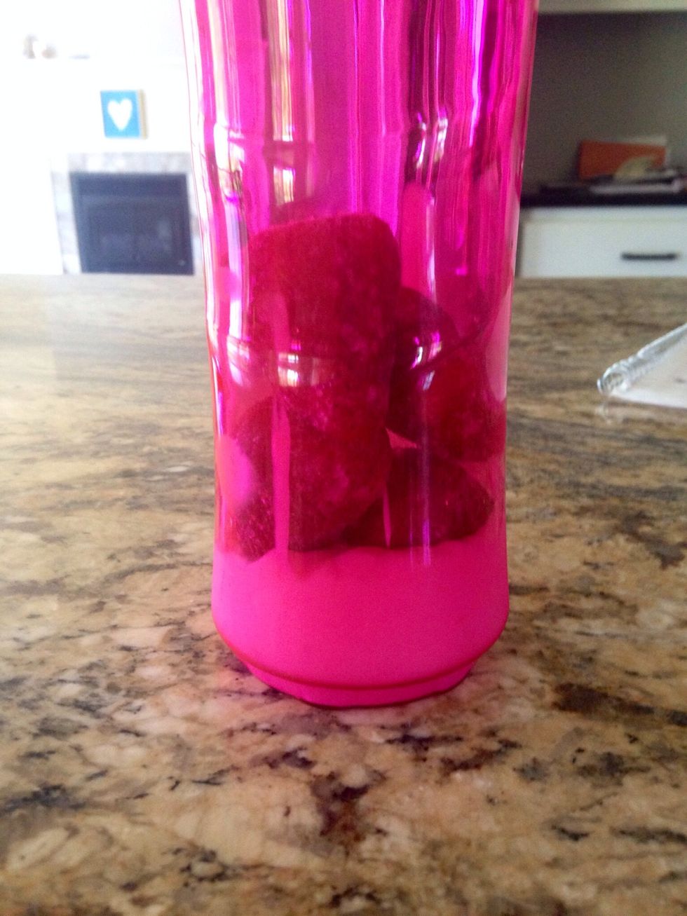 Thirdly, add about 5 frozen strawberries.