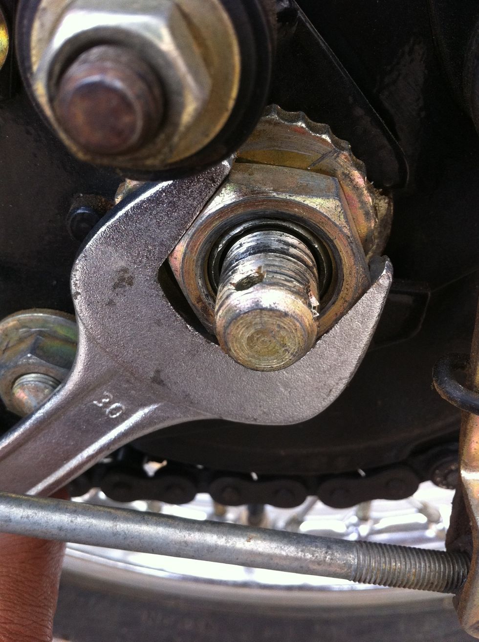 This 30mm nut holds the brake and sprocket assembly. Remove this only after you remove the rear wheel.