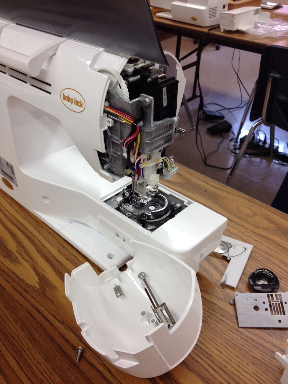 This allows you to take the side plate off. You can remove threads or fuzz if needed. To return the plate, it will go on easily if positioned correctly. No need to push hard!