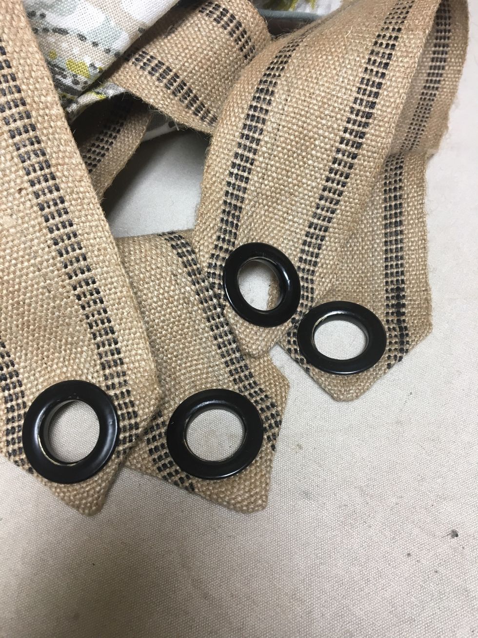 This banding doesn't tear easily so you could just punch a hole through it at the top and apply Frey Chek - depending on the hooks you are using.  We had 4 grommets from another job that were perfect.