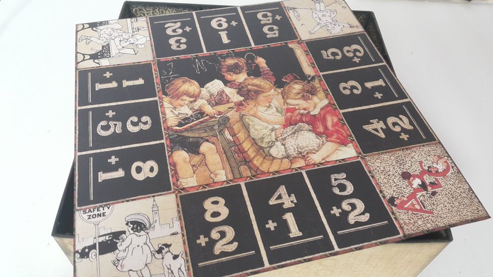This box was inspired by the famous board game \u201cMonopoly\u201d, the top of the box cover was so then decorated.