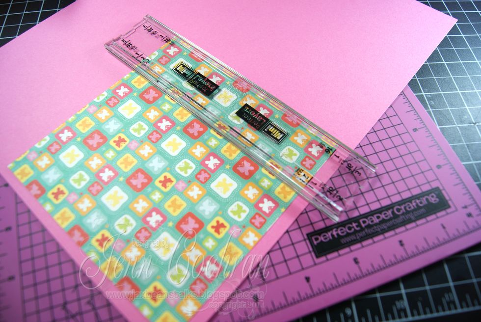 This card is a 5.25 X 5.25" card.  My designer paper is cut at 5" square.  Add adhesive from Xyron on the back and adhered it to coordinating cardstock. Use Perfect Layers Tools to create a matte.