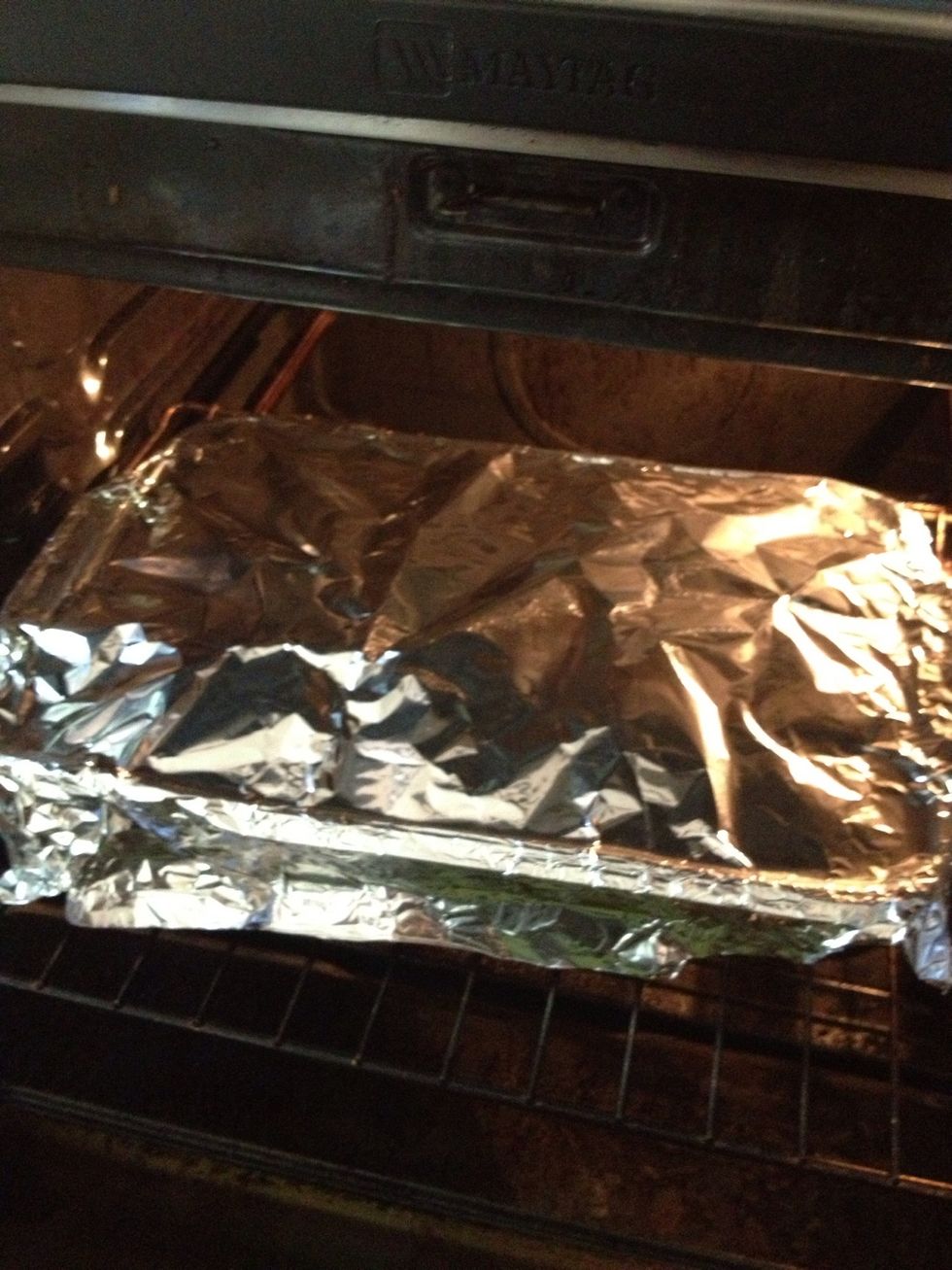 This dish goes into the 400 F oven for 90 minutes, or an hour and a half. Cover with foil for the first hour, then take it off for the last 30 minutes to brown the top and the cheese.