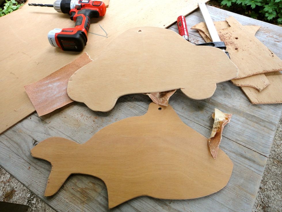This doorskin wood use to be the backboard of a buffet we never used! I cut out some rough shapes, sanded and drilled holes for hanging.