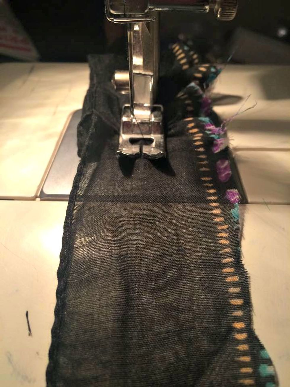 This fabric is also from a scarf I got for $1.00 clearance. I roughly cut a piece from the edge of the scarf. Here I am using my sewing machine to do a rough gather. Just pushing it under the needle.