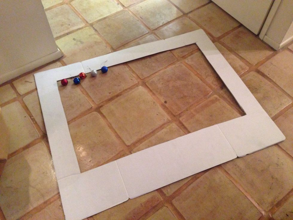 This frame is for a Holiday French themed party so I wanted to use red, white and blue decorations.  I used tape to tape them to the back so they would hang.