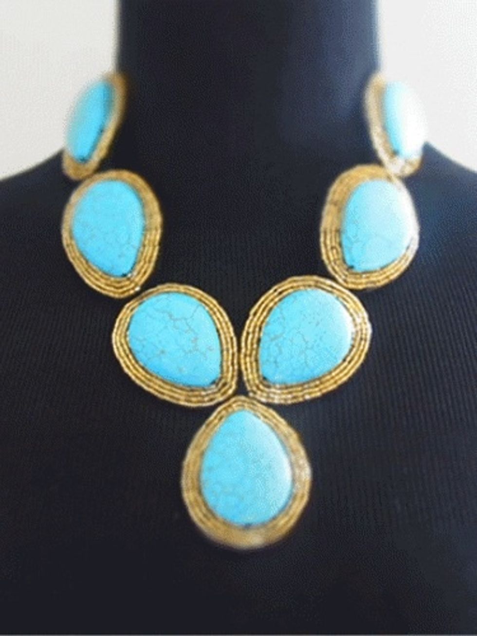 This hand embroidered bib style statement necklace consists of seven large genuine turquoise stones surrounded by gold Japanese seed beads. Enforced with black felt backing. $139