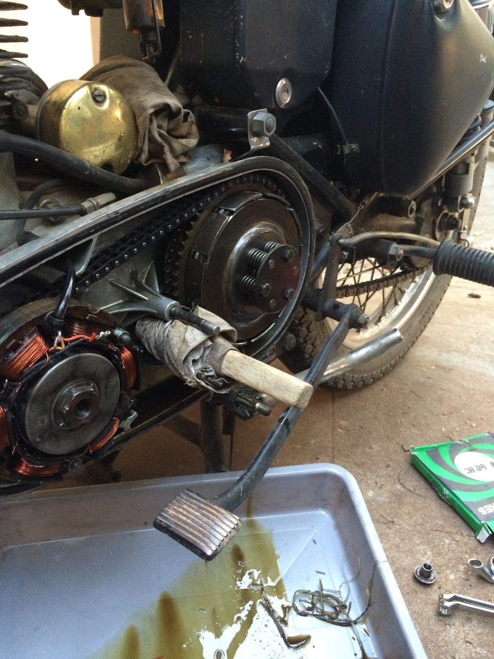 This helps lock the rotation while undoing the retaining bolts of the clutch plate housing