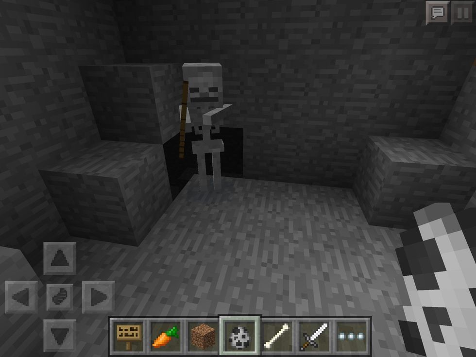 This here is a Skeleton! They will shoot at you from a distance and can pack quite a punch. You can usually hear them rattling in the caves.