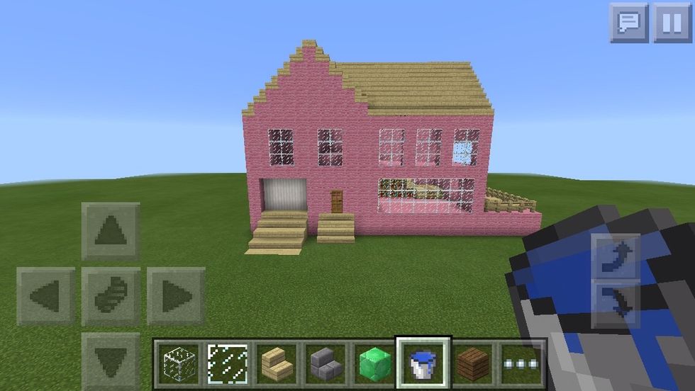 This house is made of pink wool and birch wooden planks to sorta give that doll house feeling. The garage is made of blocks of Quartz and I added a lot of windows so you can see inside