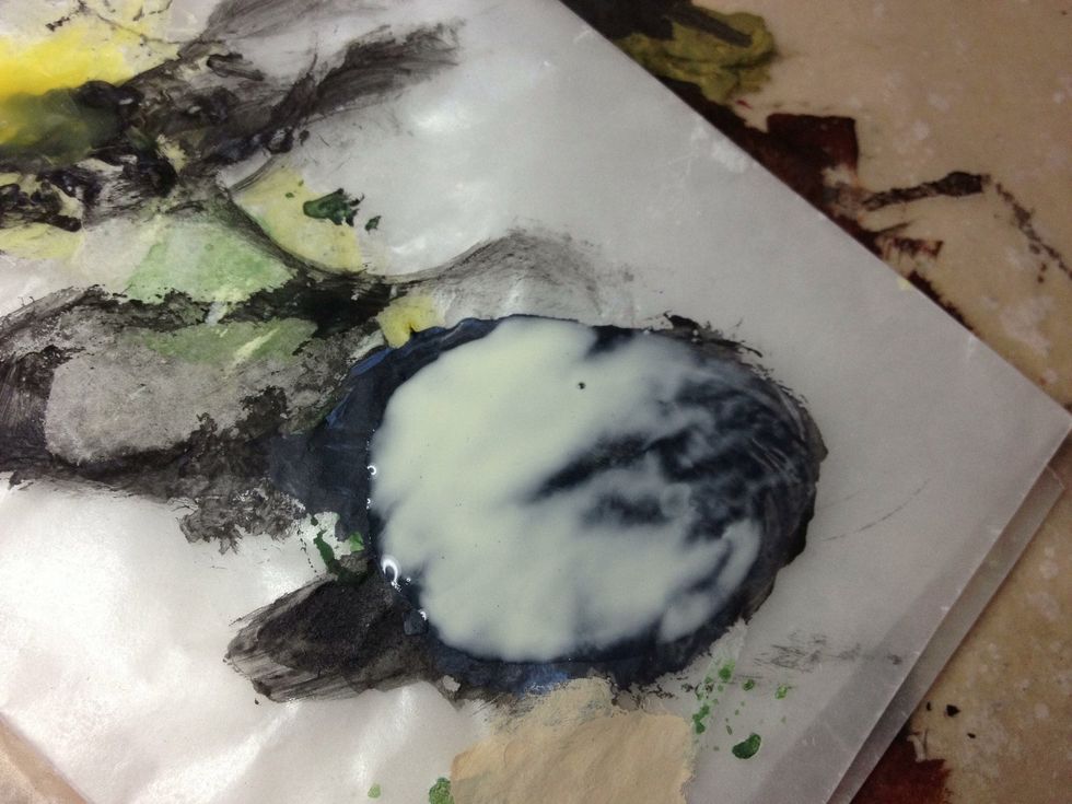 This is a 1:1 mix of carpenter's glue and water. It will moisten the pure glue and allow it to gain a firmer hold on the sand.