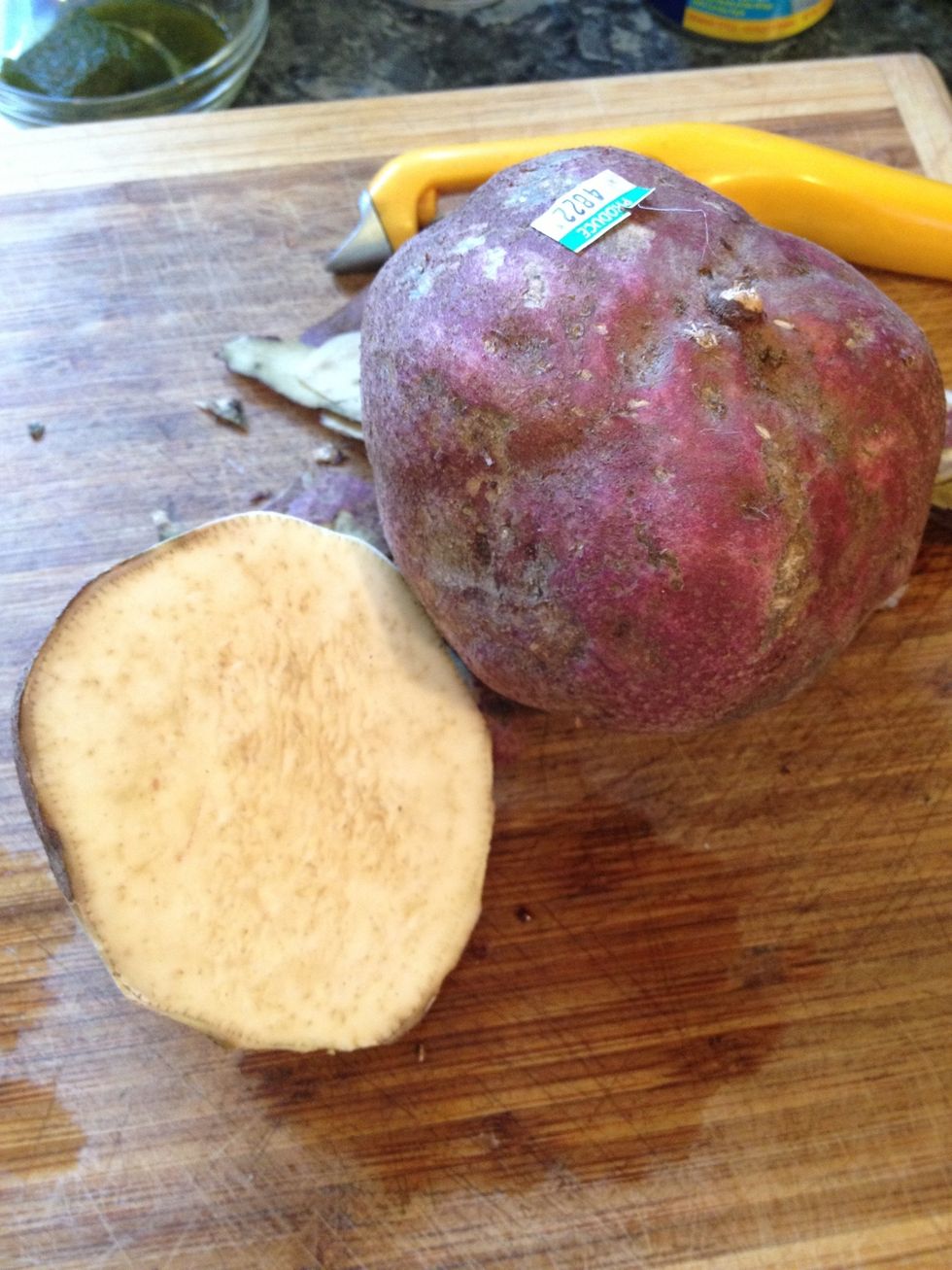 This is a batata. The flesh is somewhat pinkish with brown spots. It is grown in the Caribbean and has a flavor that is similar to a sweet potato, yet more starchy.