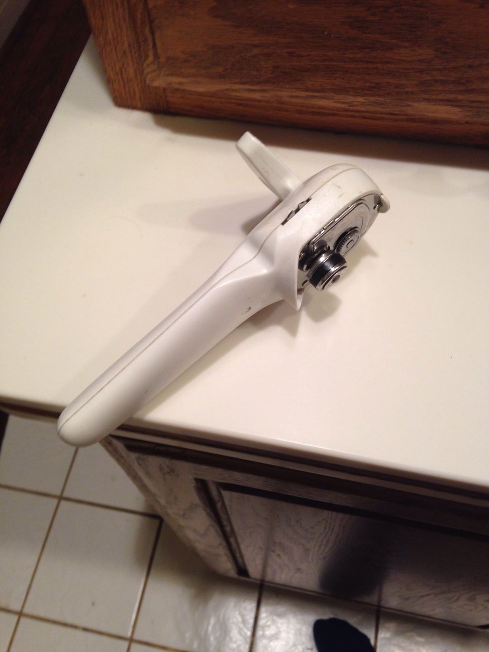 This is a can opener. It is used to open cans. I can use this if I'm having trouble opening a can.