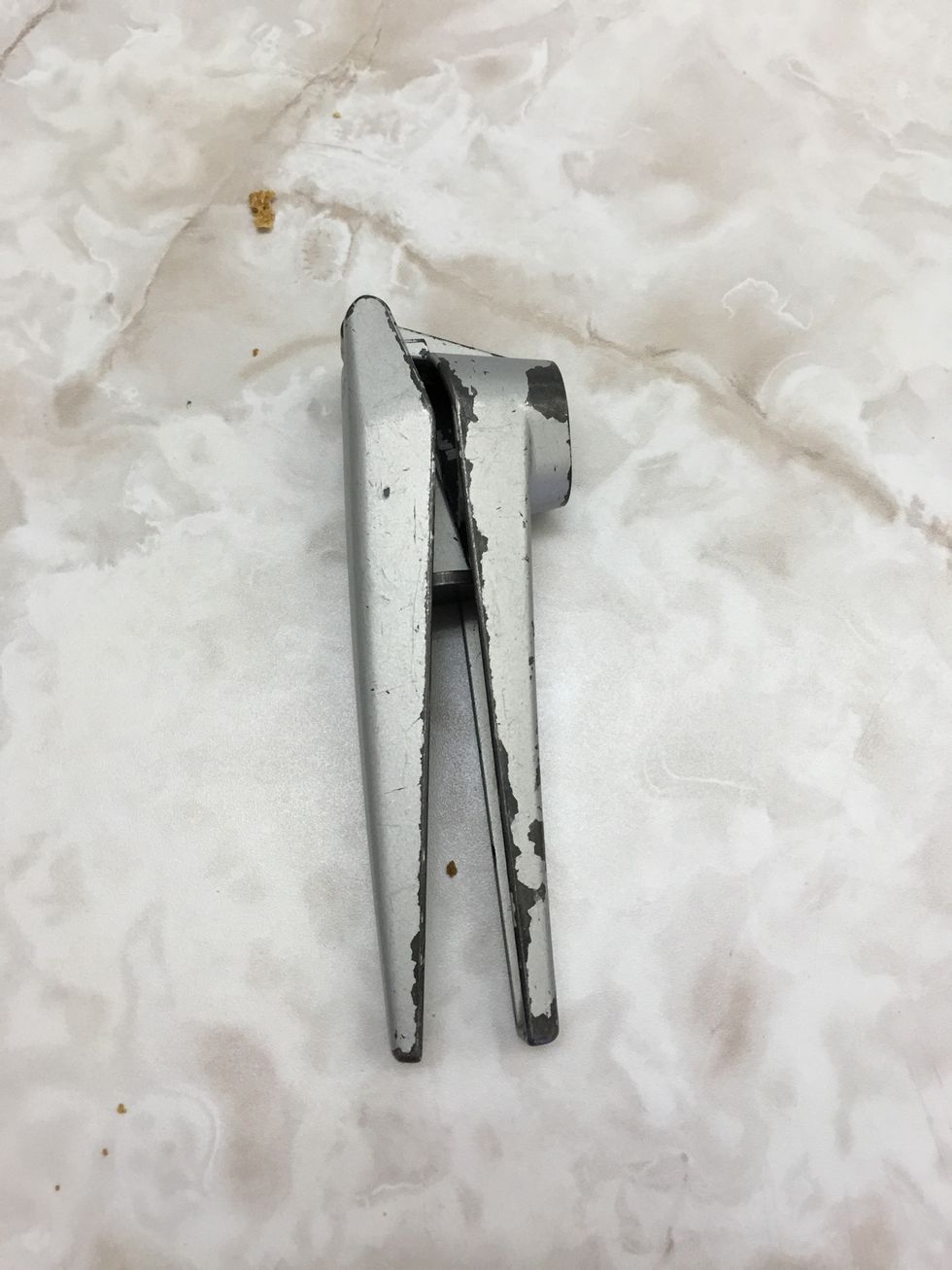 This is a garlic press it is used to crush or mince whole pieces of garlic cloves