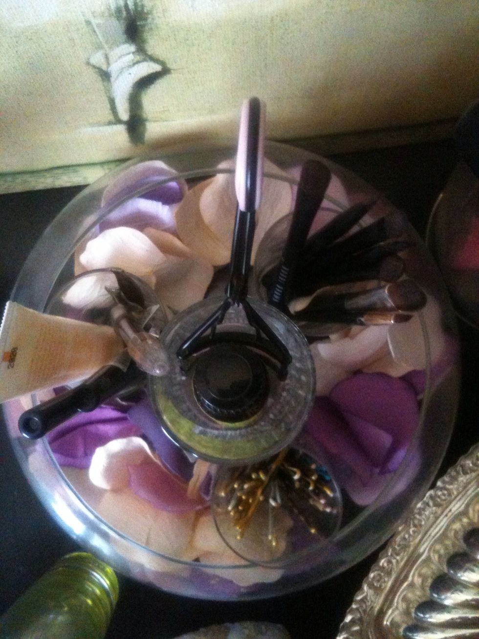This is a glass bowl with a wine glass in the middle and shot glasses around it , in each I have bobby pins , makeup brushes ect