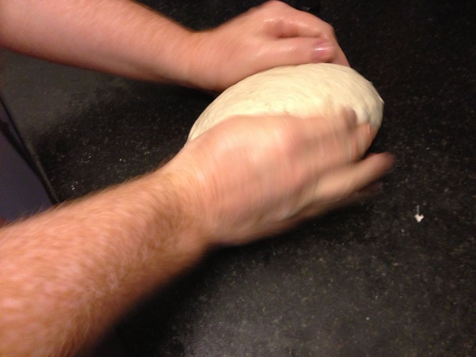 This is a good opportunity to practice rounding the dough into a ball. Cup and twist the dough with your hands on the surface, gently folding underneath to form a ball.