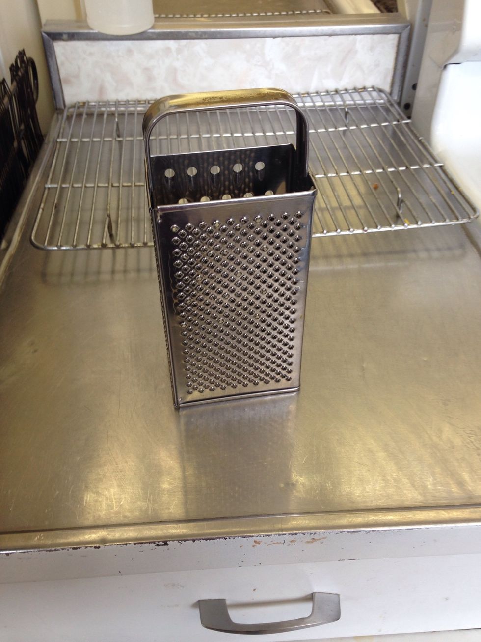 This is a grater. A grater is a kitchen utensil used to grate foods into fine pieces. I can grate cheese.