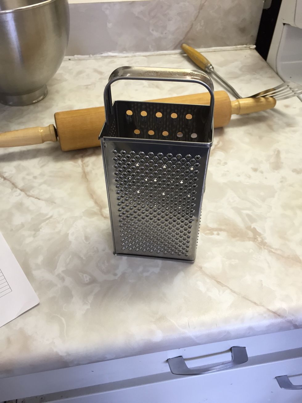 This is a grater. You use it to make a large piece of food into smaller pieces. I can use a grater when I grate cheese
