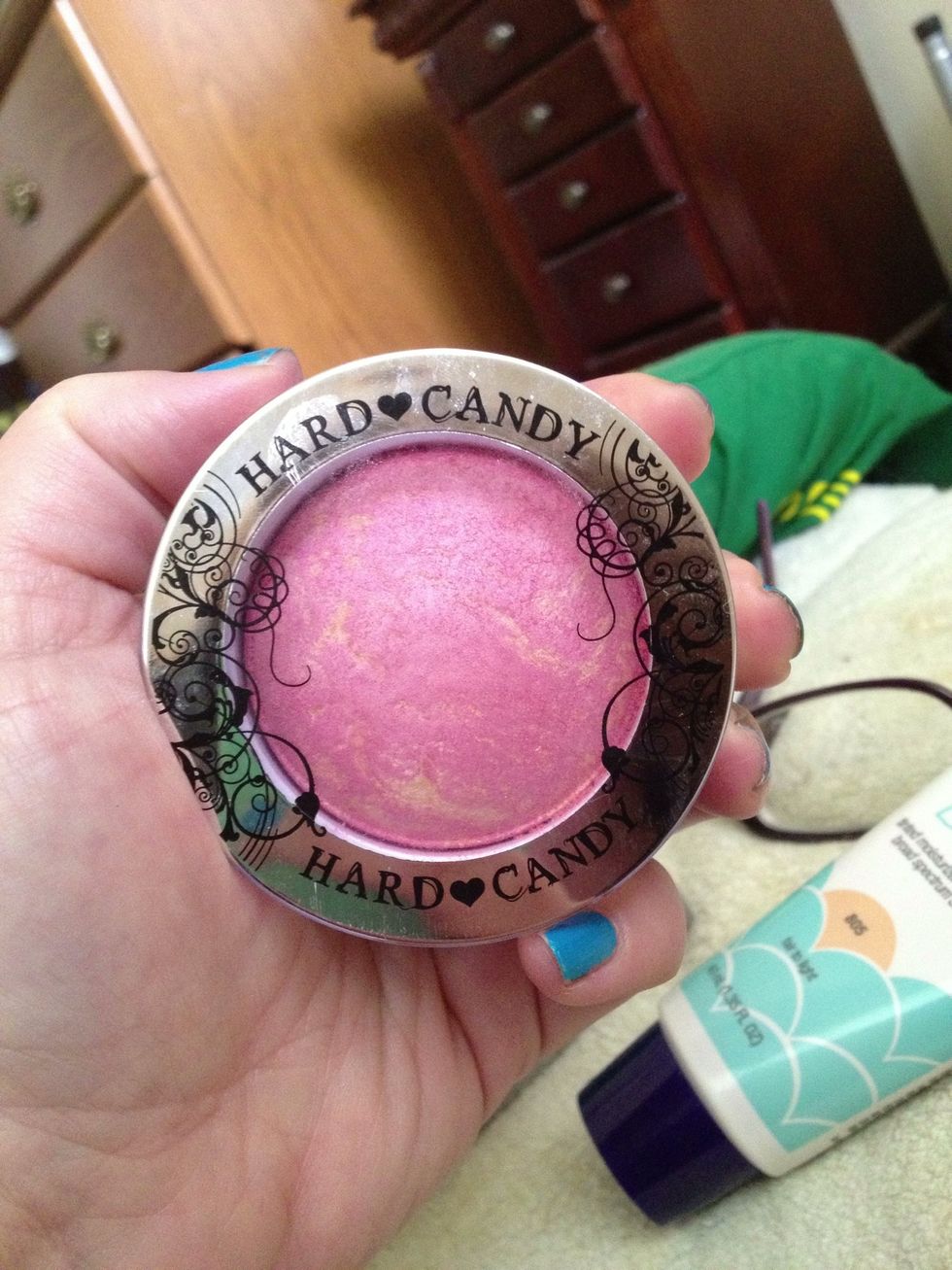 This is a light pink blush (shade is Living Doll) by Hard Candy. It is lightly shimmery so it shows up well in both day and night. It can also be used wet for a more dramatic look.
