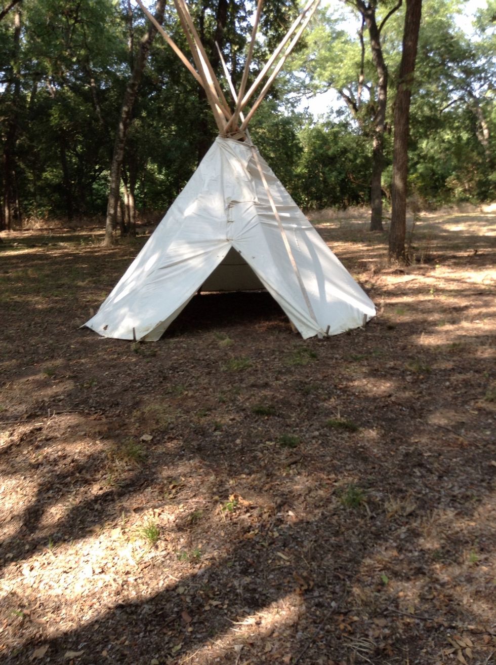 This is a model of a Indian teepee normally the white would be leather or buffalo hide or the fur of a animal.