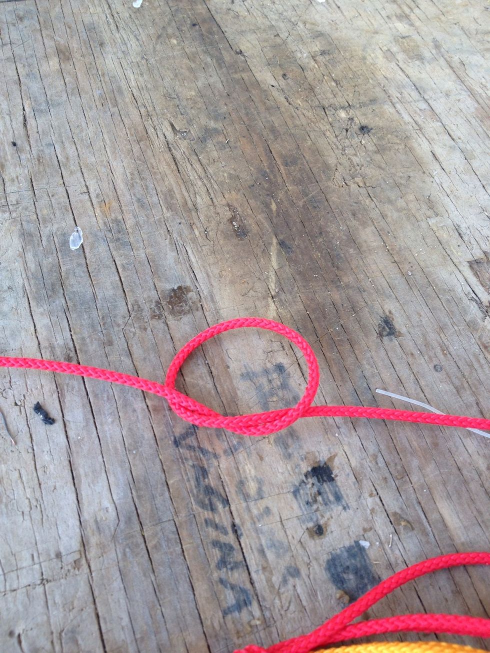 This is a picture of the overhand knot you just did. But with a single rope instead of all 4 ropes. Reference photo. .