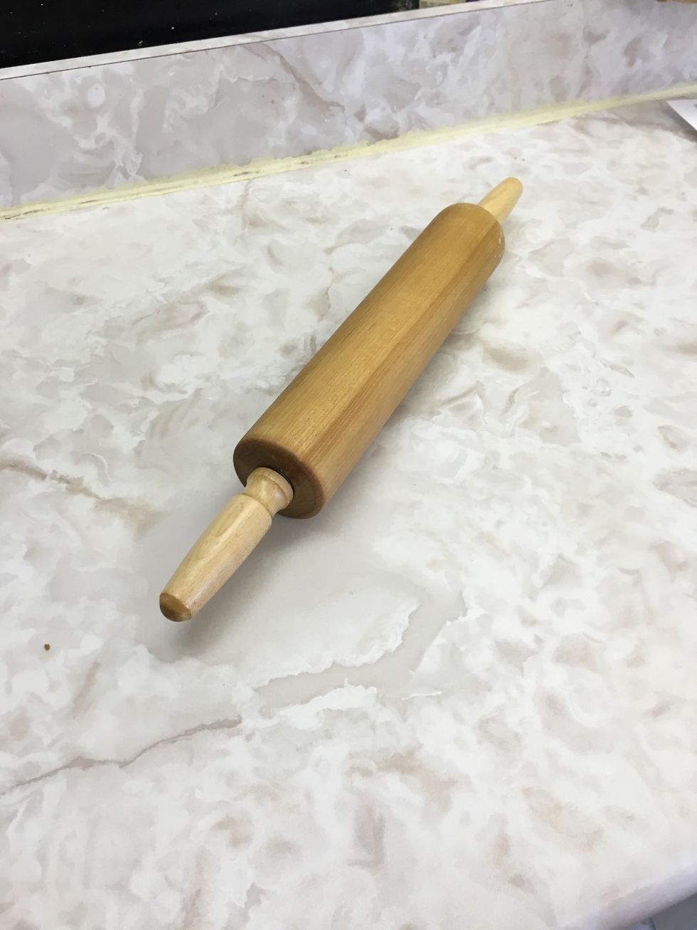 This is a rolling pin and it is used to roll out dough