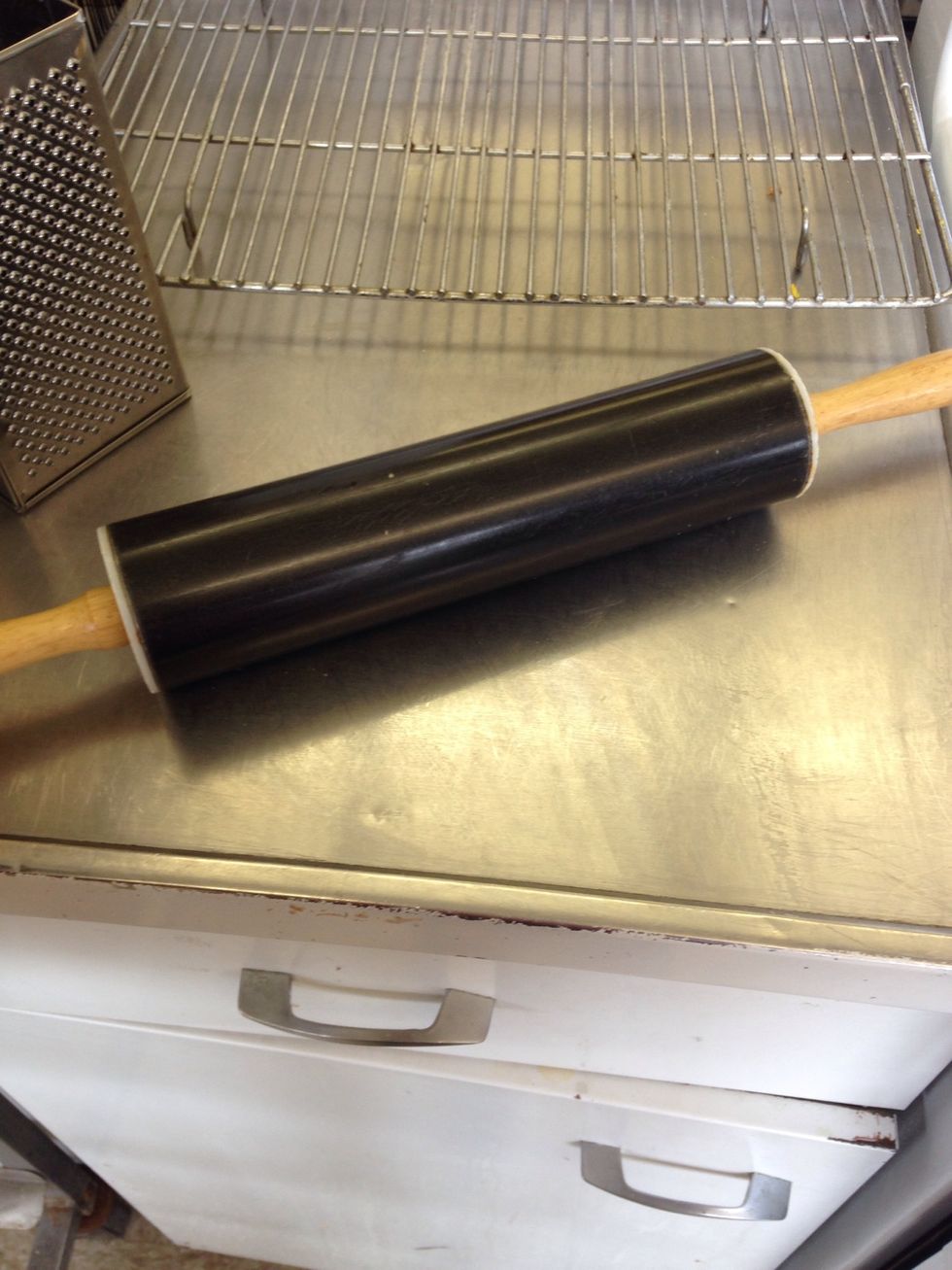 This is a rolling pin which is used to flatten and shape dough. I can use this to flatten cookie dough.