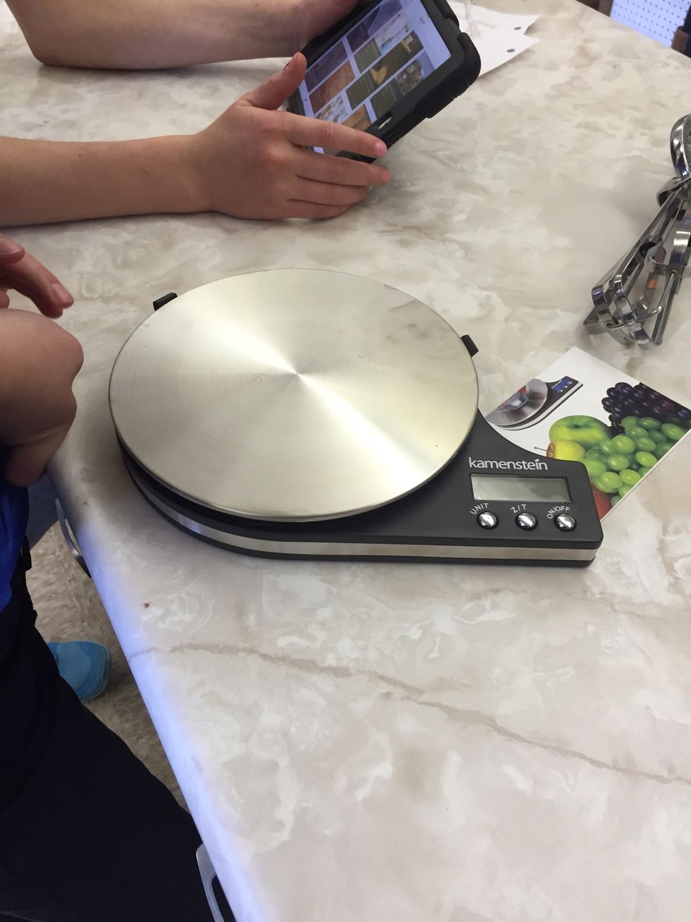 This is a scale it is used measuring how many grams a type of food is. I can measure foods using a scale.