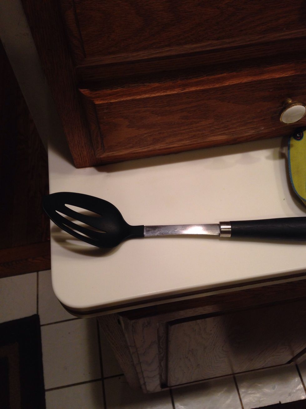 This is a slotted spoon which is used to retrieve items from a cooking liquid. I can use this to get items without having liquid on it.