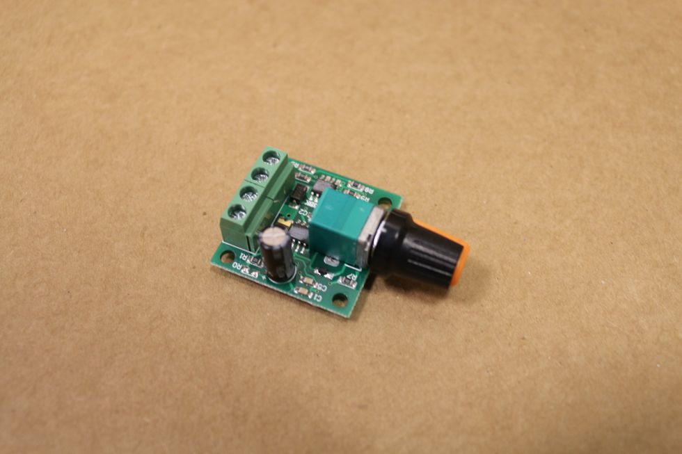 This is a speed control which you will use to control your motor. Search for "DC motor speed controller".  Try this link http://goo.gl/XpbQup