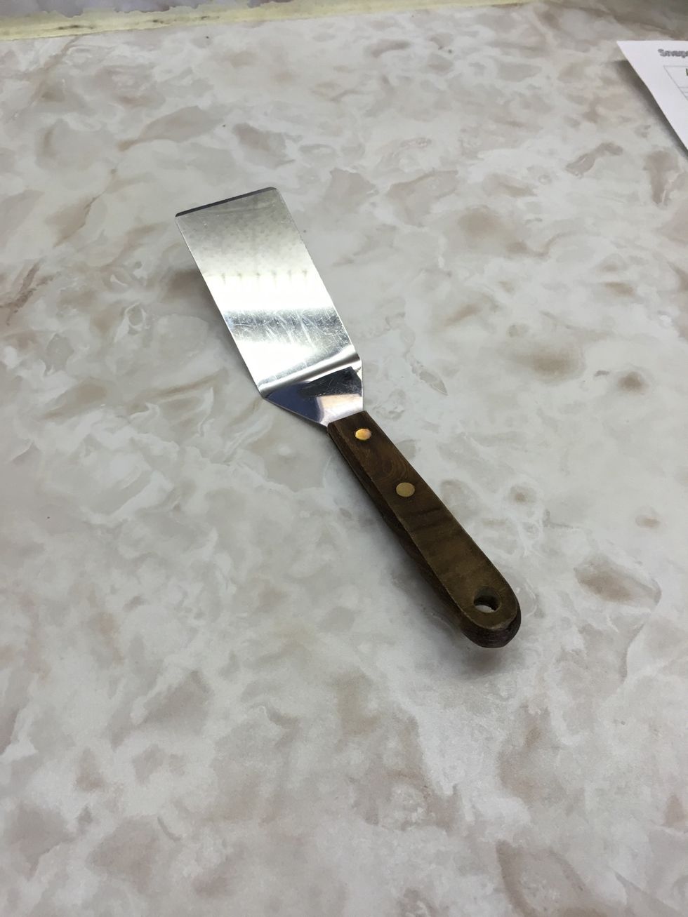 This is a straight edge spatula which can be used to lift cookies from a baking tray