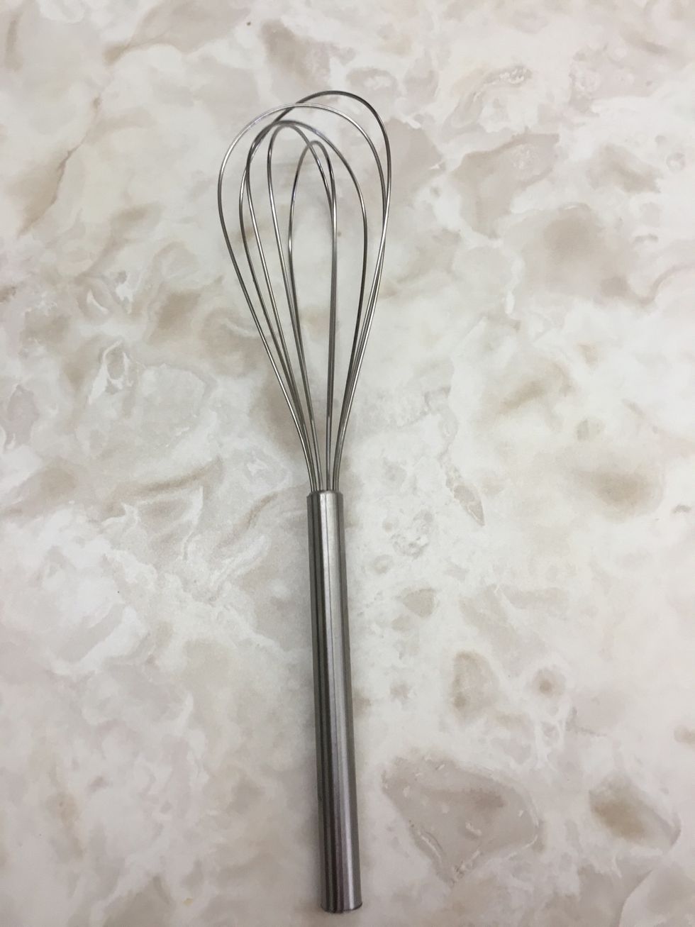 This is a whisk it is used to quickly mix liquid ingredients