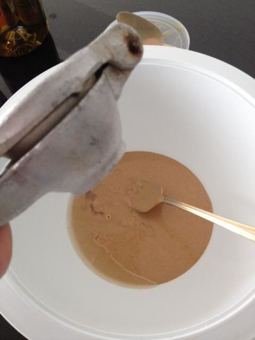 This is about 1/3 to 1/2 cup of tahini. Add a little water, a clove of garlic, about a tsp of cumin, and some salt. Start stirring to mix.