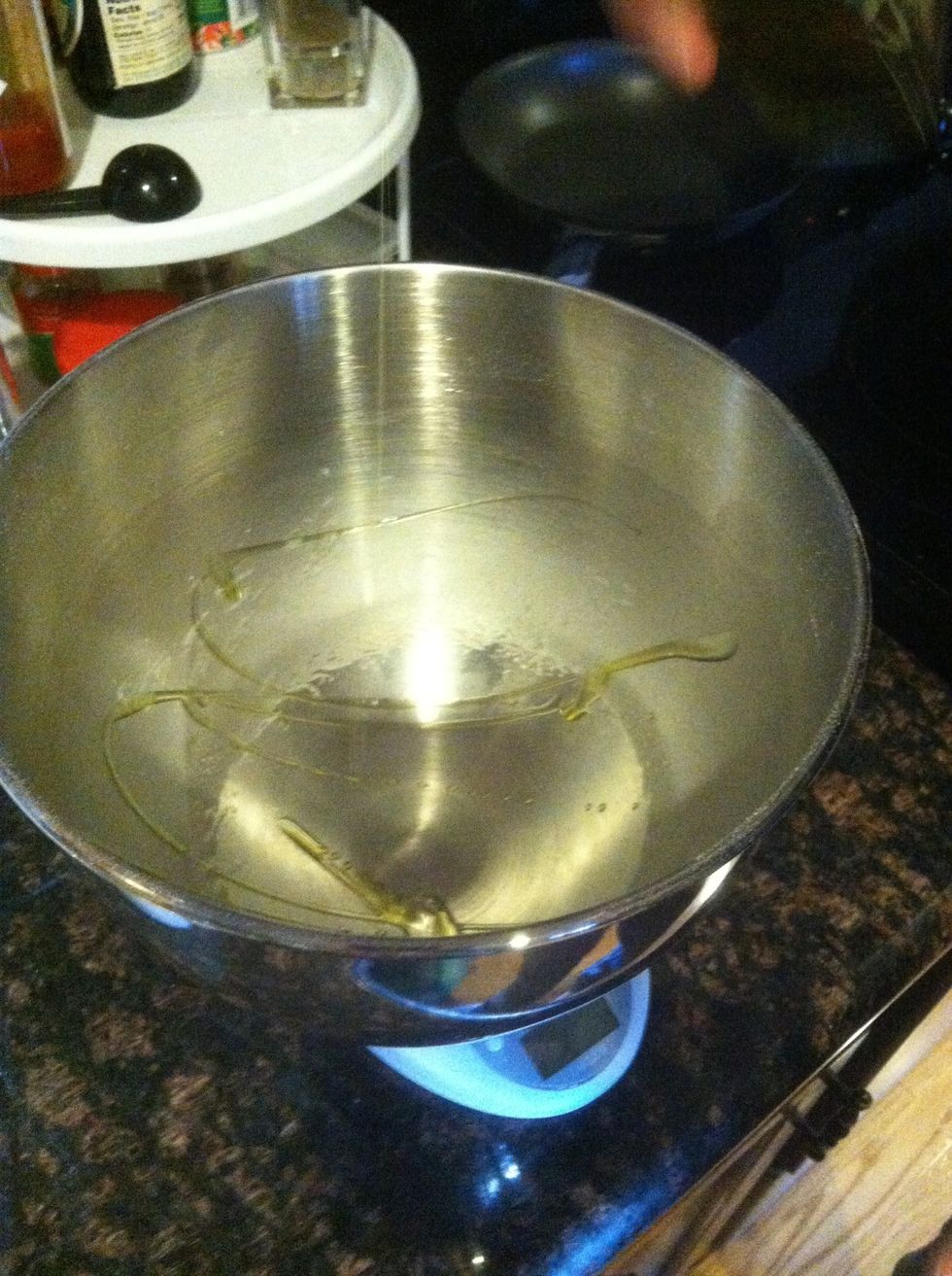 This is actually a double batch, so half goes into another container and half goes back into the mixer bowl. Put olive oil in so it doesn't stick.