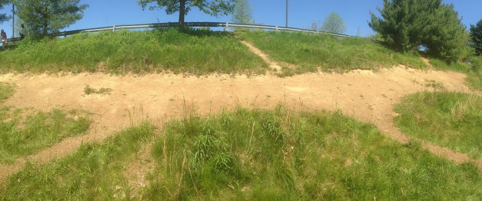 This is an example of erosion because the wind and water poured down and moved all the sediment to the bottom of the hill.
