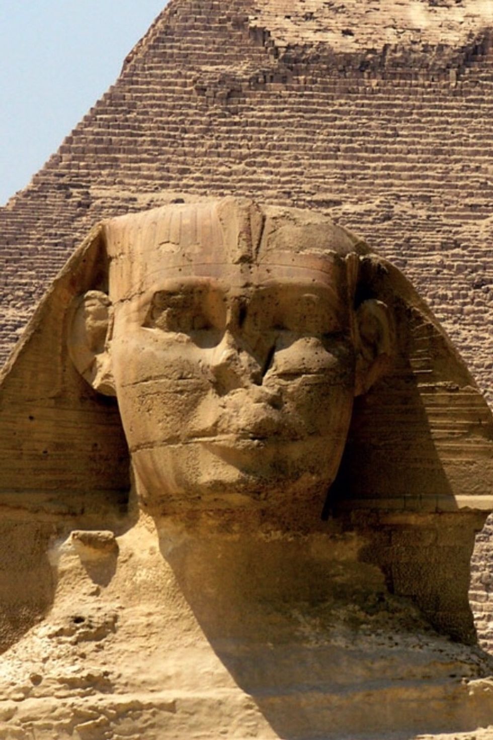 This is an example of erosion. Over time, sand particles and water have made this statue look not as pleasant as it used to. It wore down the face into a different shape.