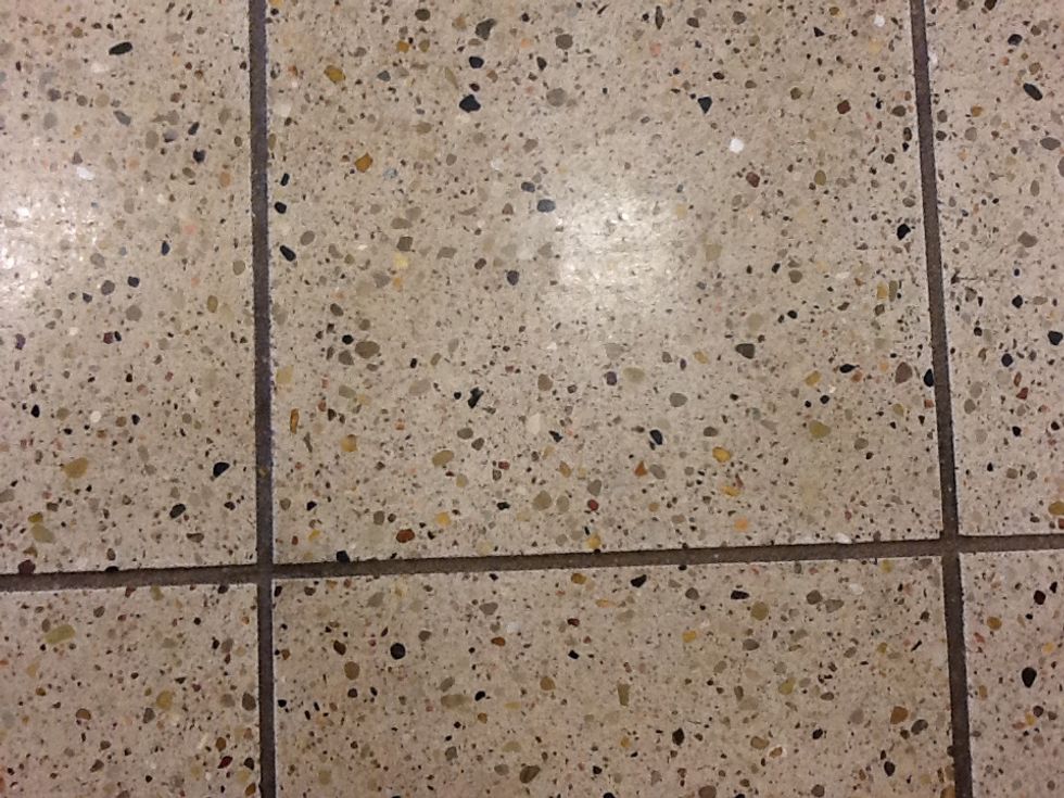 This is an example of perpendicular lines. It is the tile floor in the hallways.