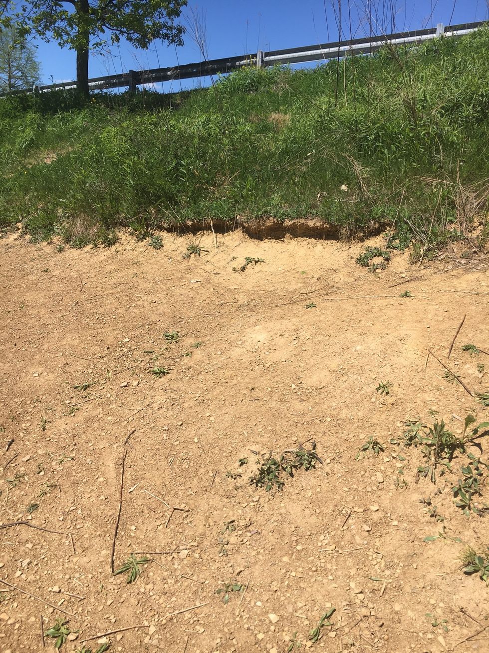 This is erosion because the ground eroded away and now the ground is no longer level.