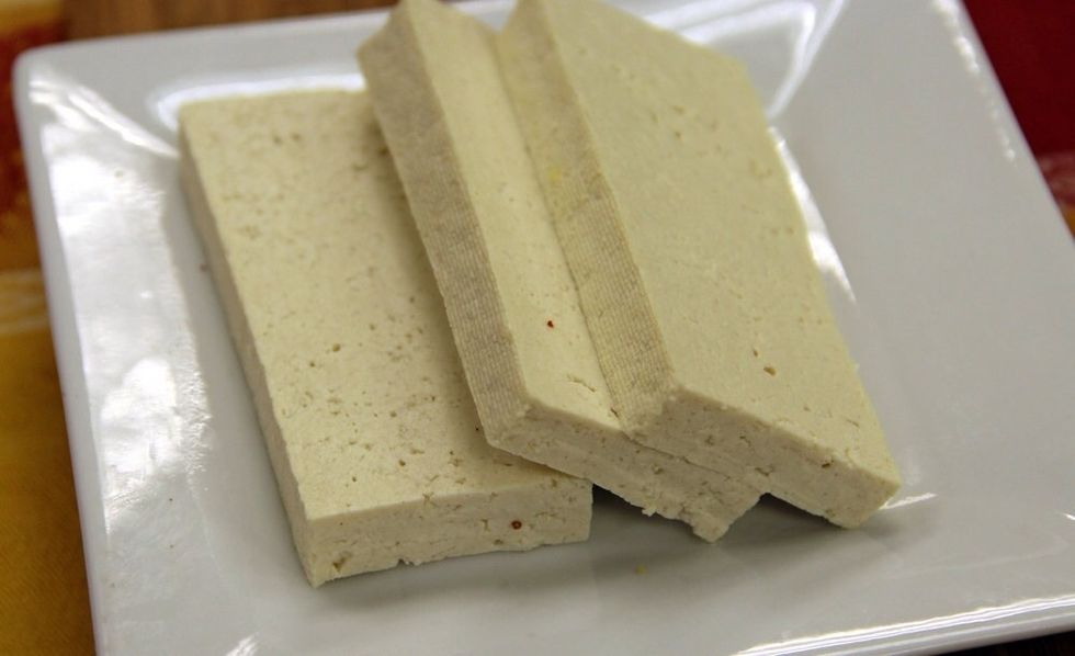 This is extra-firm tofu. It has a dense texture and is perfect for frying, grilling or broiling. Here, we have cut the block into \u00bd-inch slices.