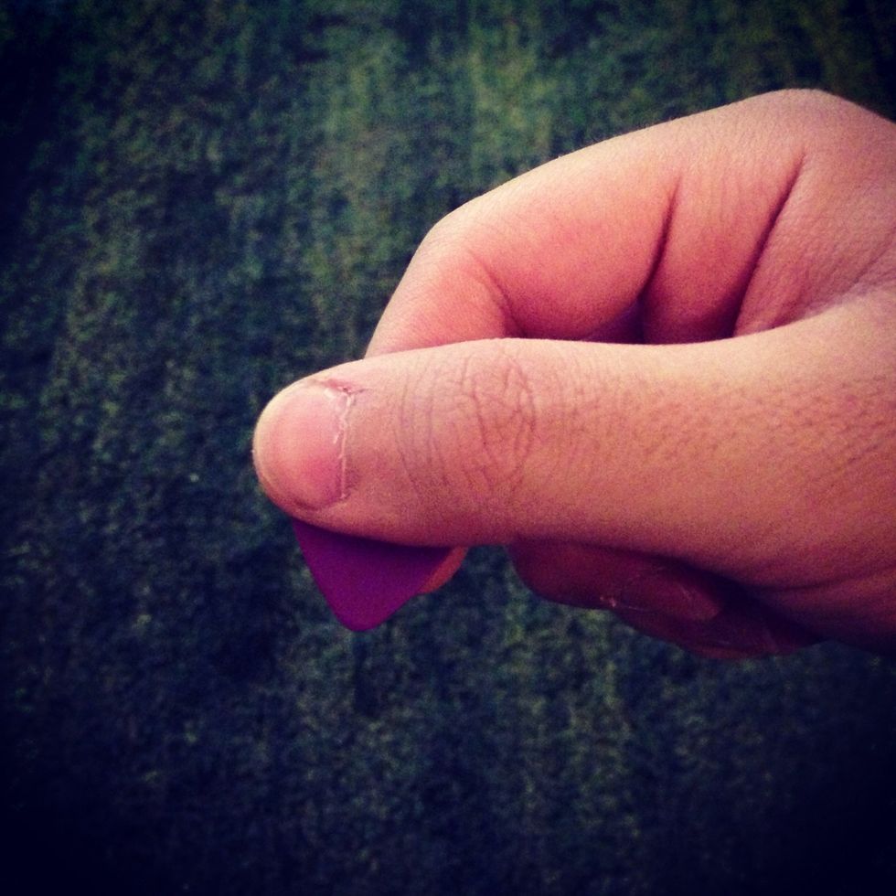 This is how I hold my pick (it's a Dunlop tortex ,great pick)