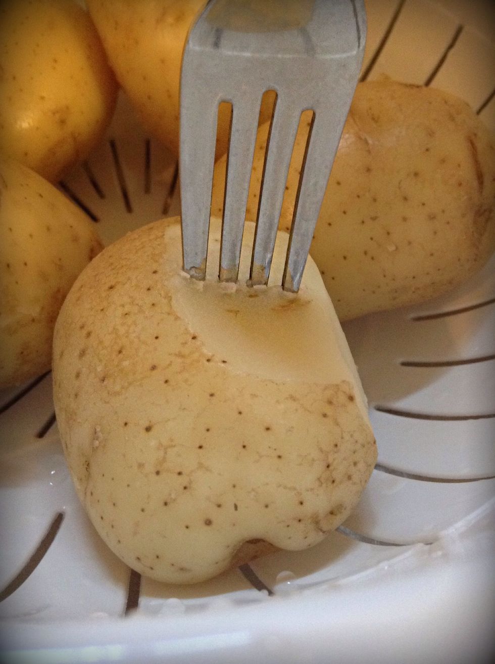 This is how is check to see if the potatoes are properly done. The fork is able to get into the potato slightly but not enough to go all the way through.
