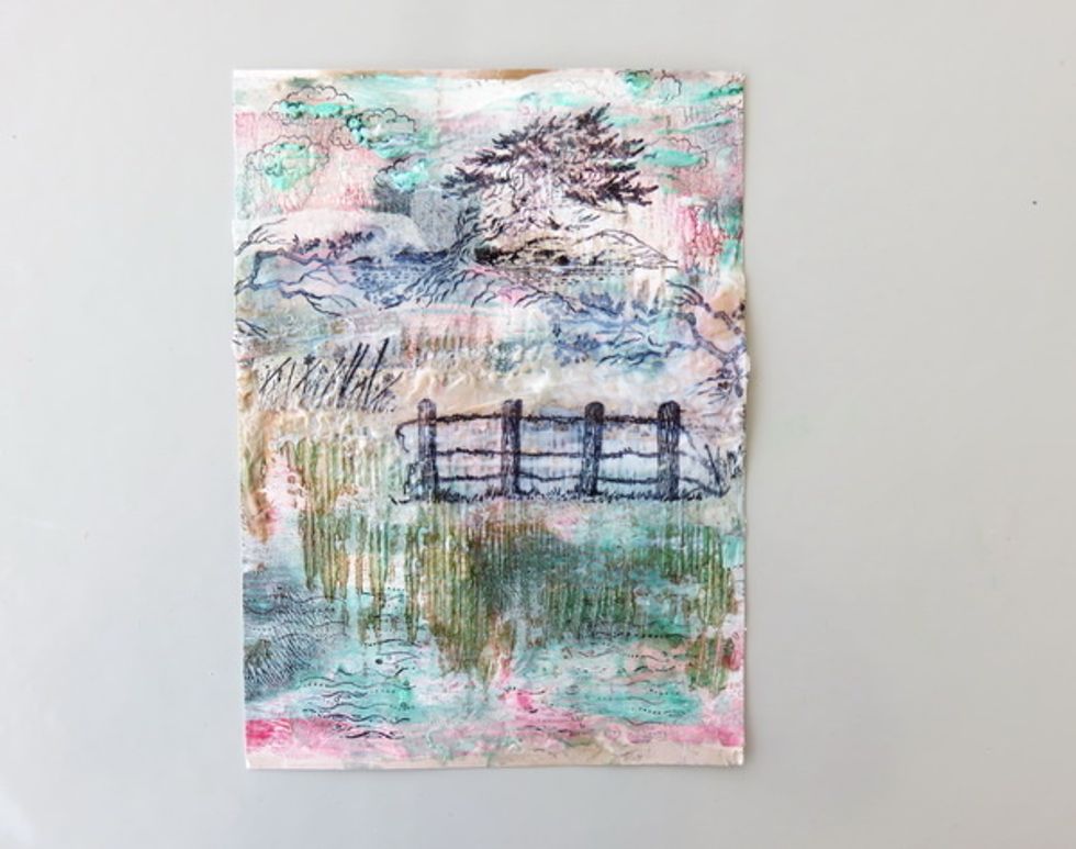 This is how it looks after more stamped over tissue images were added to the page. Stamp clouds over the textured paint on the top and waves on the bottom directly over the page.